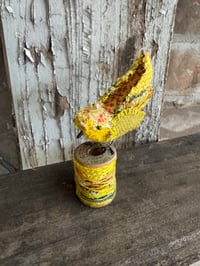 Image 2 of Small yellow bird on spool