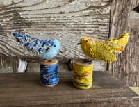 Image 4 of Small yellow bird on spool