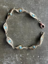 Image 1 of wire wrapped gold and emerald bracelet