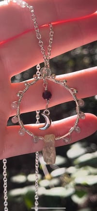 Image 2 of labradorite circular wire wrapped necklace with crescent moon and garnet in center