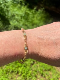 Image 3 of wire wrapped gold and emerald bracelet