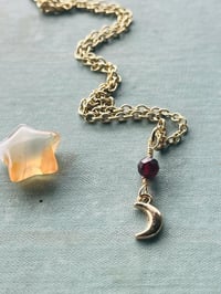 Image 3 of gold crescent moon necklace with red garnet