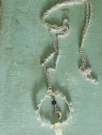 Image 5 of labradorite circular wire wrapped necklace with crescent moon and garnet in center