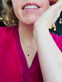 Image 6 of wire wrapped heart with tiny garnet in gold