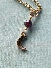 Image 4 of gold crescent moon necklace with red garnet