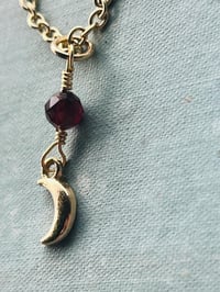 Image 5 of gold crescent moon necklace with red garnet