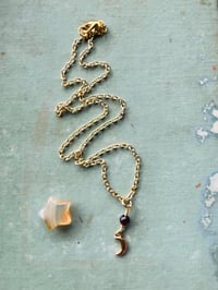 Image 6 of gold crescent moon necklace with red garnet