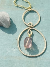 Image 1 of gold hammered spiral necklace with tiny purple fluorite stone