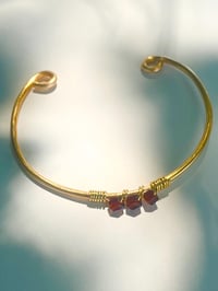 Image 1 of dark red garnet bangle in gold