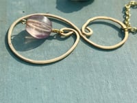 Image 2 of gold hammered spiral necklace with tiny purple fluorite stone