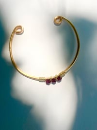 Image 3 of dark red garnet bangle in gold