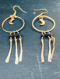 Image 1 of dangly gold moon earrings with lapis lazuli
