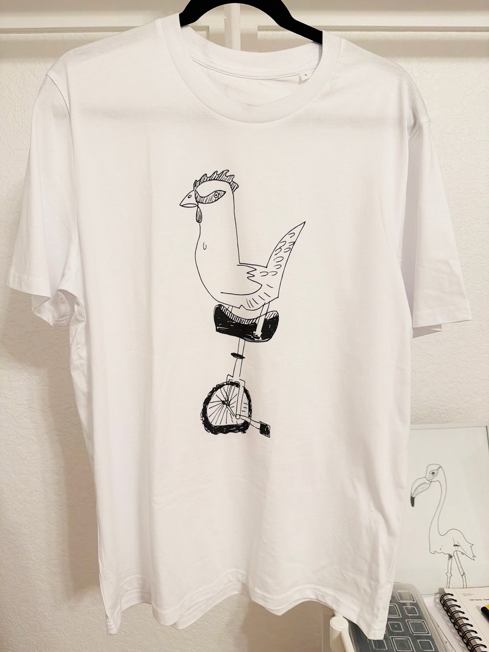 CHICKEN WITH A UNICYCLE - Unisex organic cotton t-shirt