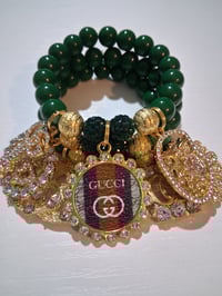 Image 1 of Green G in gold