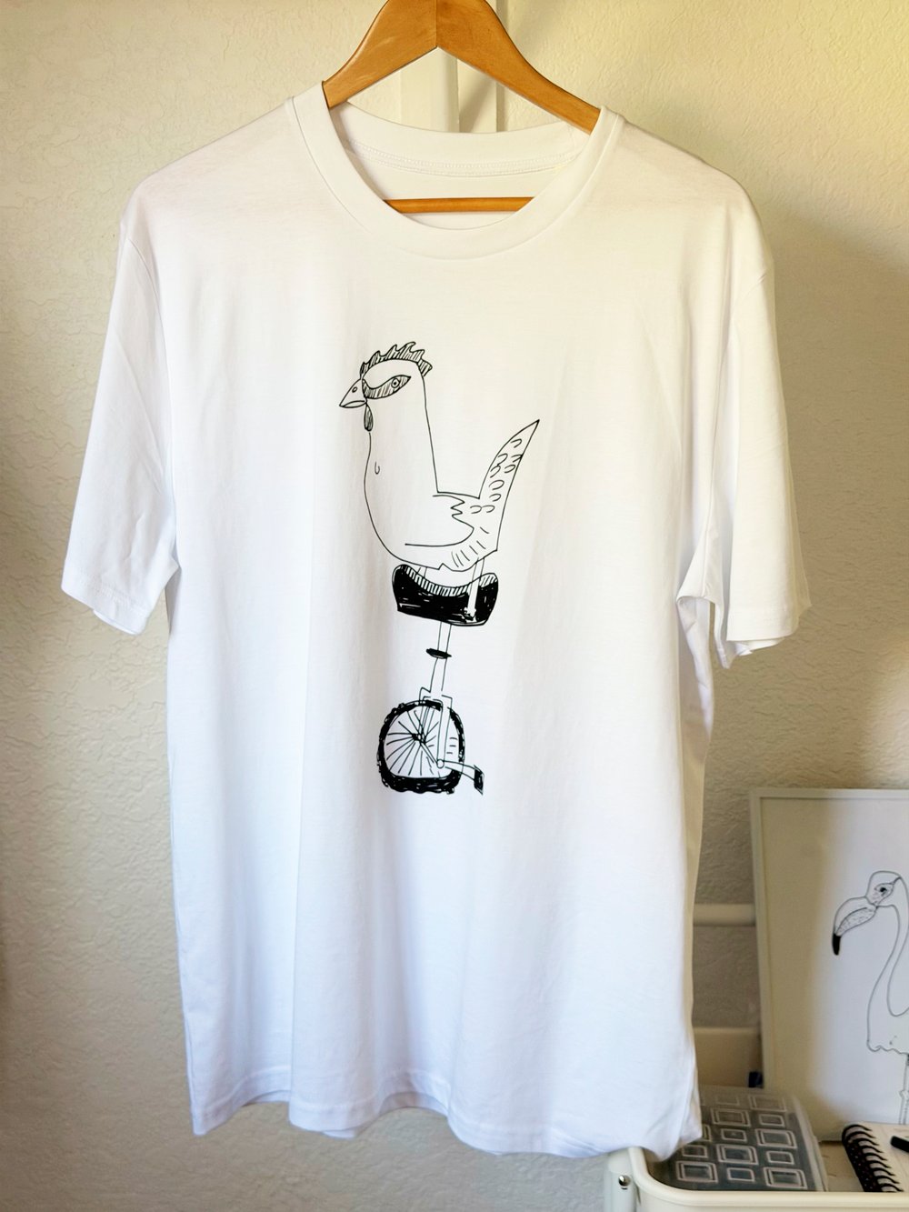 CHICKEN WITH A UNICYCLE - Unisex organic cotton t-shirt