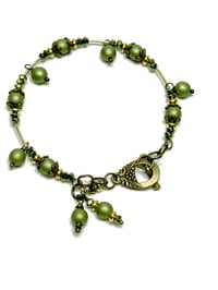 Image 1 of 1PC. OLIVE/METALLIC GREEN FIRE POLISHED GLASS BEADED MEMORY WIRE BRACELET