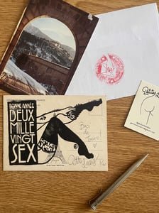 Image of « Bonne année deux mille sex » Lino print on vintage postcard