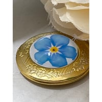 Image 1 of Gold-Plated Round Locket | Forget-Me-Not Blue Flower Design