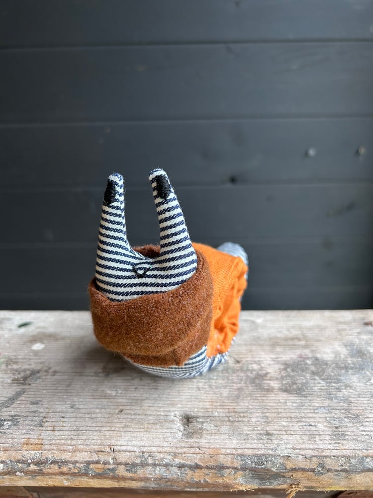 Image of Small Handmade Orange Linen Snail Wearing A Brown Woollen Scarf