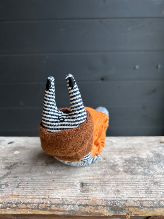 Image of Small Handmade Orange Linen Snail Wearing A Brown Woollen Scarf