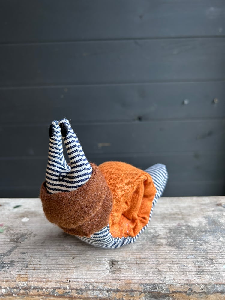 Image of Small Handmade Orange Linen Snail Wearing A Brown Woollen Scarf