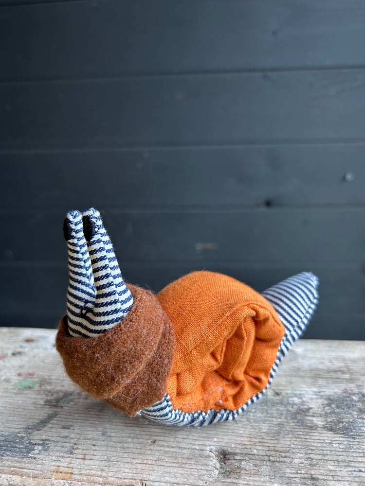 Image of Small Handmade Orange Linen Snail Wearing A Brown Woollen Scarf