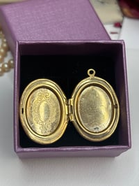 Image 2 of Gold-Tone SOS Engraved Oval Locket Pendant With Floral Design In Gift Box