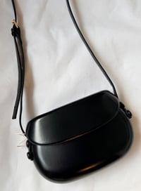 Image 1 of Leather handbag with a rounded shape Black 