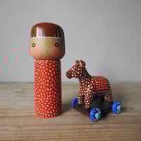 Image 1 of girl with a toy horse X