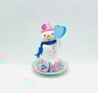 Image 1 of Strawberry Bundt cake snowman with blue lollipop and be mine conversation heart