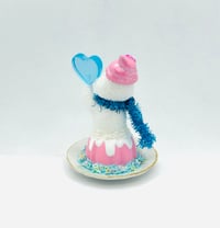 Image 2 of Strawberry Bundt cake snowman with blue lollipop and be mine conversation heart