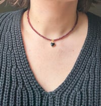 Image 1 of Garnet with Onyx Heart Charm Necklace