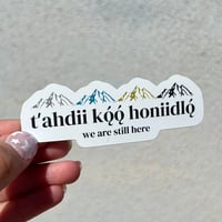 Image 1 of t'ahdii koǫ́˛́ honiidlo˛́ "we are still here" sticker