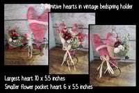 Primitive hearts in bedspring stand.