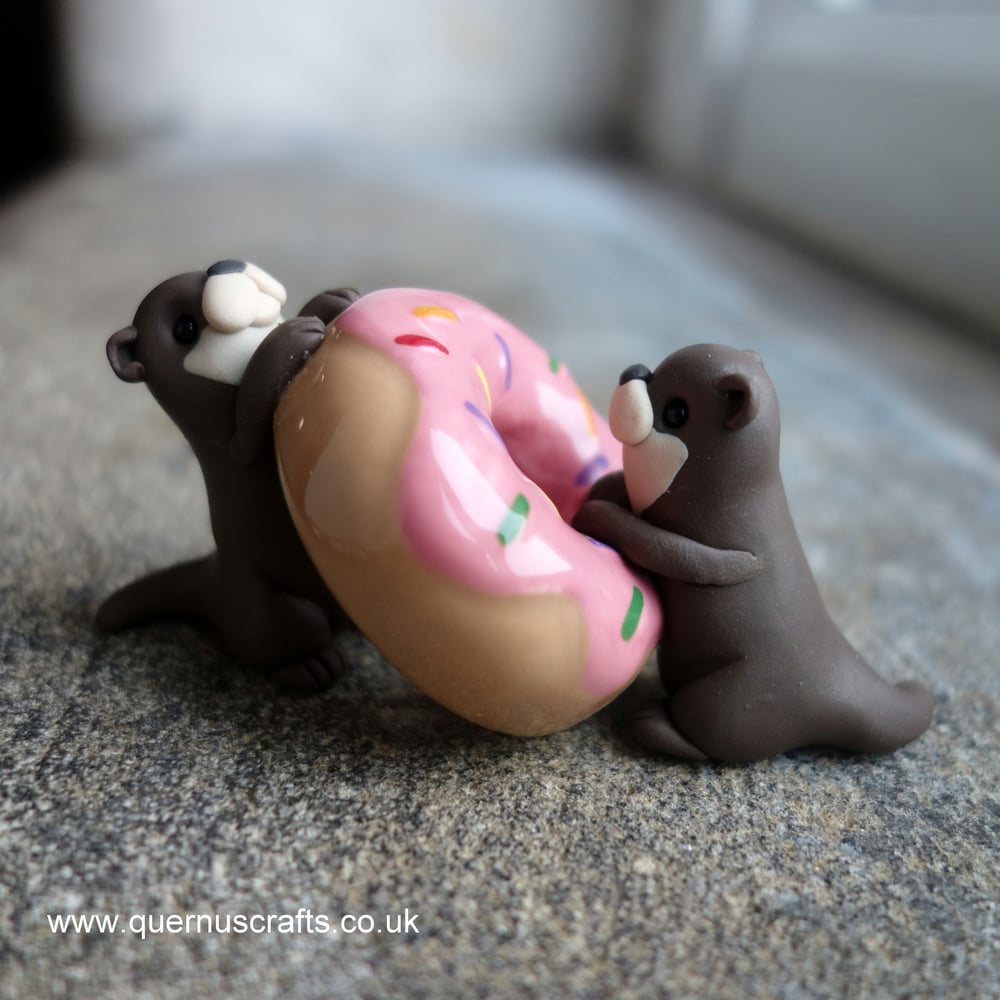 Two Wee Otters with Donut
