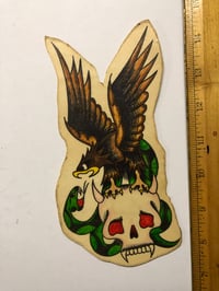 Image 1 of 1960’s Spaulding & Roger’s hand colored pork chop flash Eagle Skull Snake