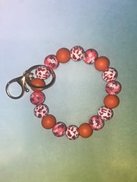 Rust and coral wristlet keychain 