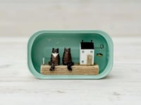 Image 1 of A cat house made from a sardine can, home to two tabby cats.