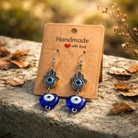 SILVER PALM EYE AND BLUE HEART DANGLE