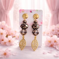 GOLD AND BLACK PATTERN BEADS WITH GOLD LEAF DANGLE