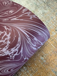 Image 1 of 'White Fantasy vein' on Maroon paper
