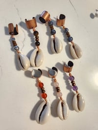 Image of Cowrie loc and braid jewelry 