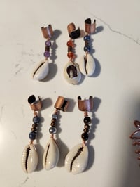 Image of Cowrie loc and braid jewelry 