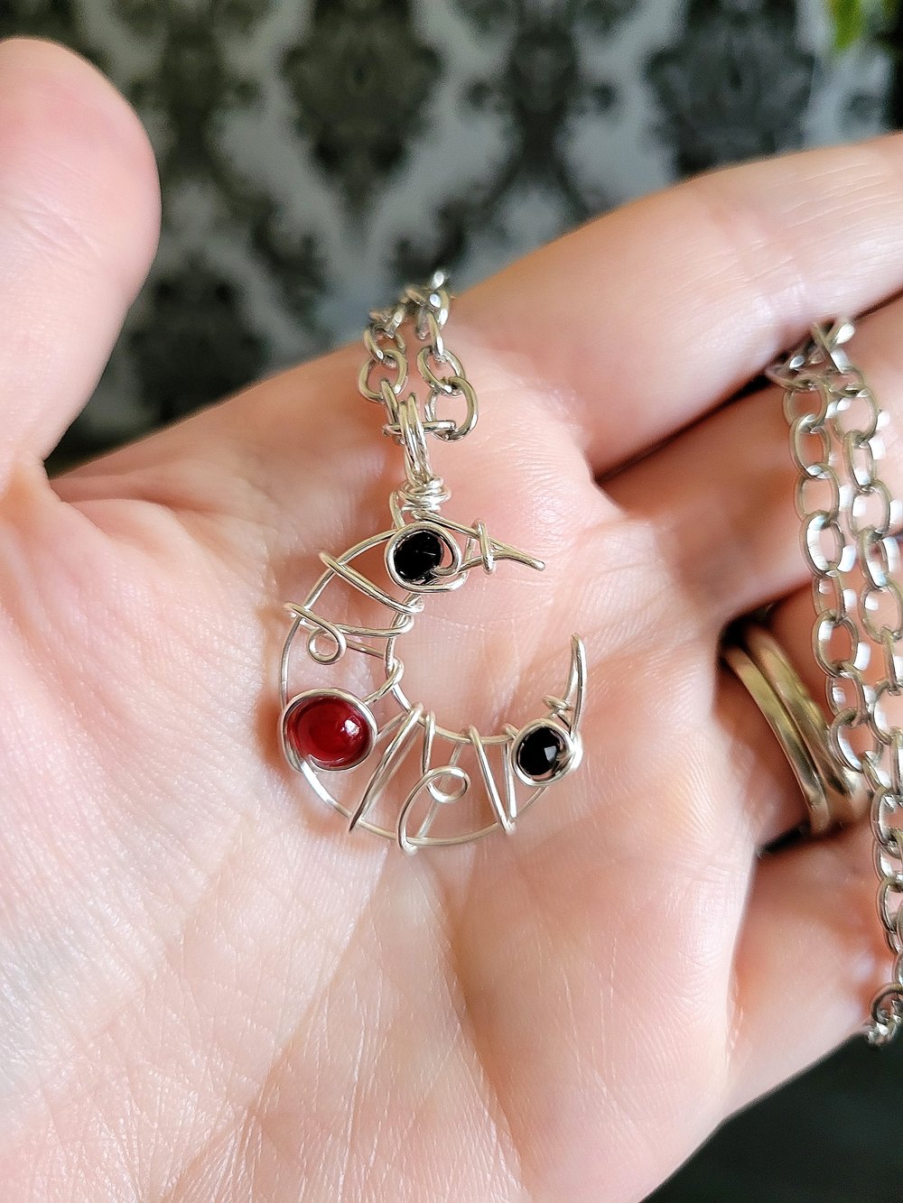 Image of Small Black and Red Beaded Crescent Moon Pendant Necklace