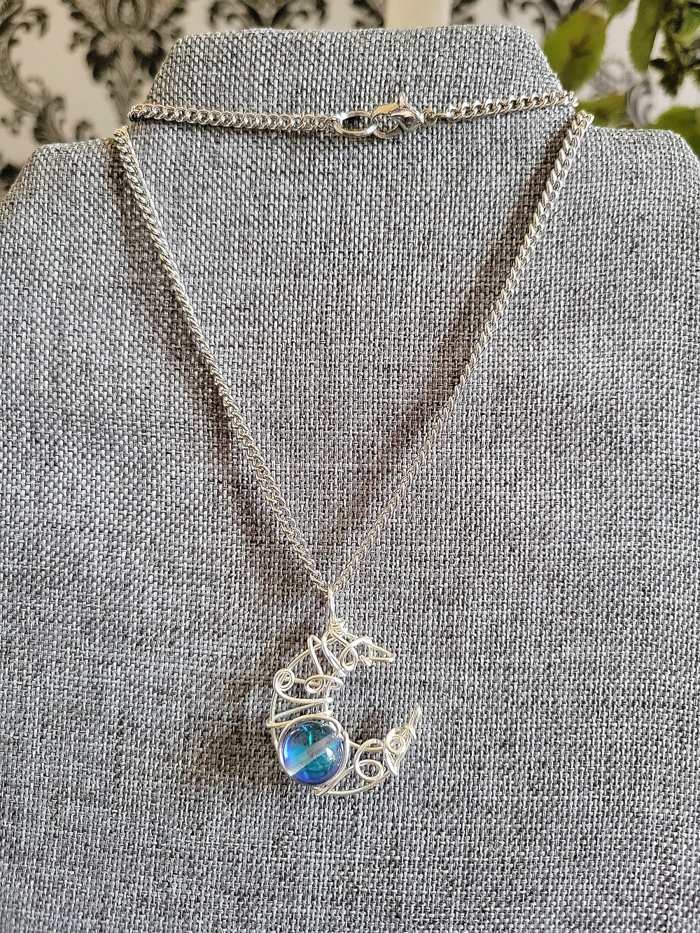 Image of Silver Crescent Moon Pendant Necklace with Glowing Blue Bead