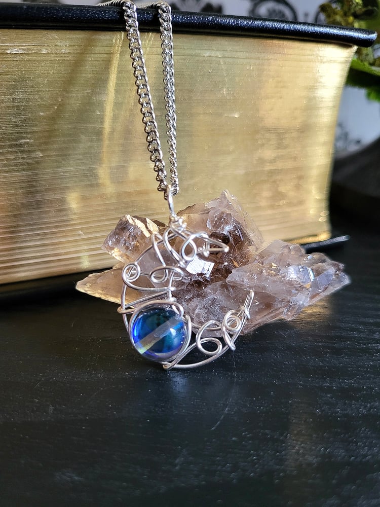 Image of Silver Crescent Moon Pendant Necklace with Glowing Blue Bead