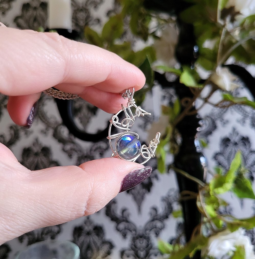 Image of Silver Crescent Moon Pendant Necklace with Glowing Blue Bead