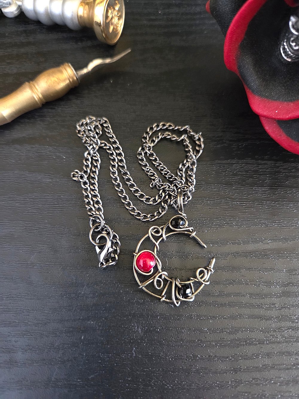 Image of Small Black and Red Beaded Crescent Moon Gunmetal Pendant Necklace