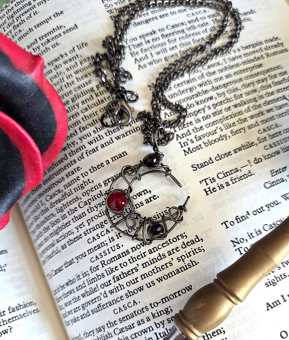 Image of Small Black and Red Beaded Crescent Moon Gunmetal Pendant Necklace