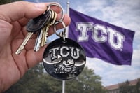 TCU black disk engraved in green 